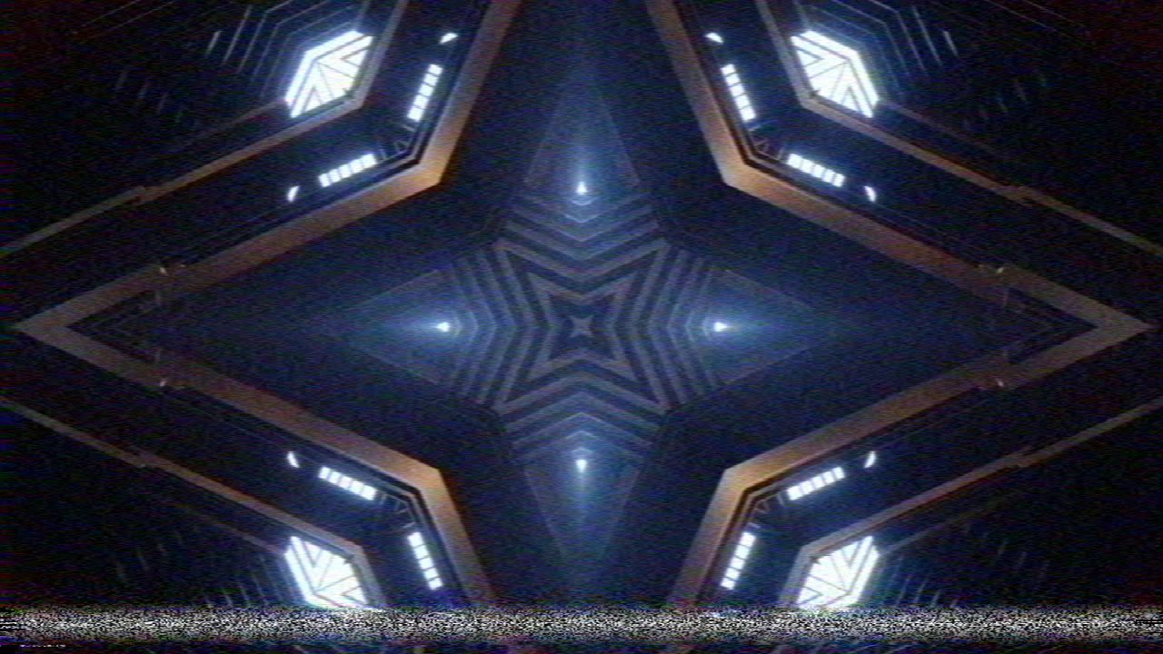 Resolume’s demo clip IntoTheGlow_02 through the deck: a symmetrical tunnel of lit panels, soft, the colour late and blotchy on the copper edges, and a band of tracking noise across the bottom